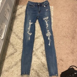 Size 00 American Eagle skinny ripped jeans. Lightly worn. No damage or stains.